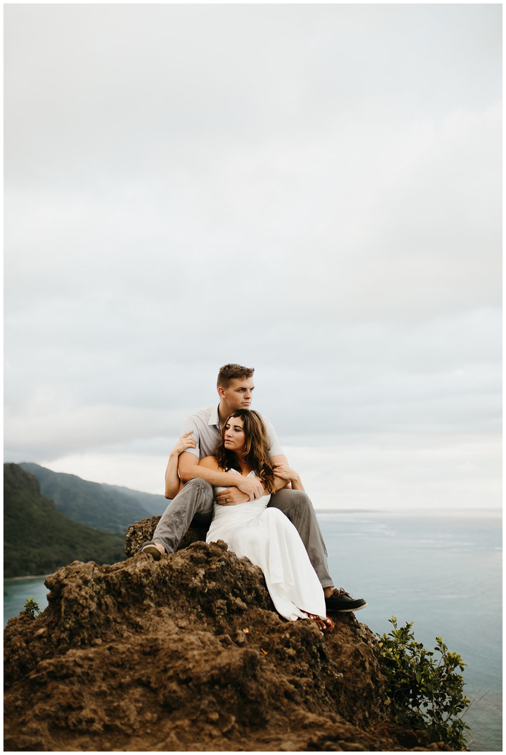 couple sitting on rocks in hawaii