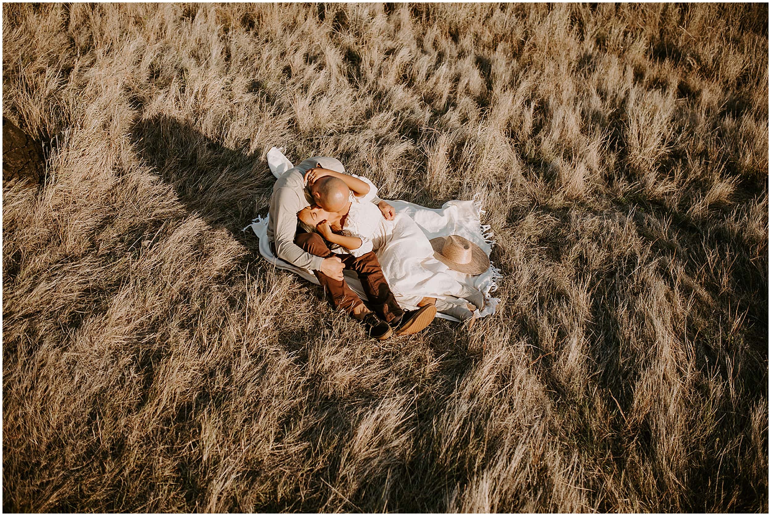 couple laying on hillside