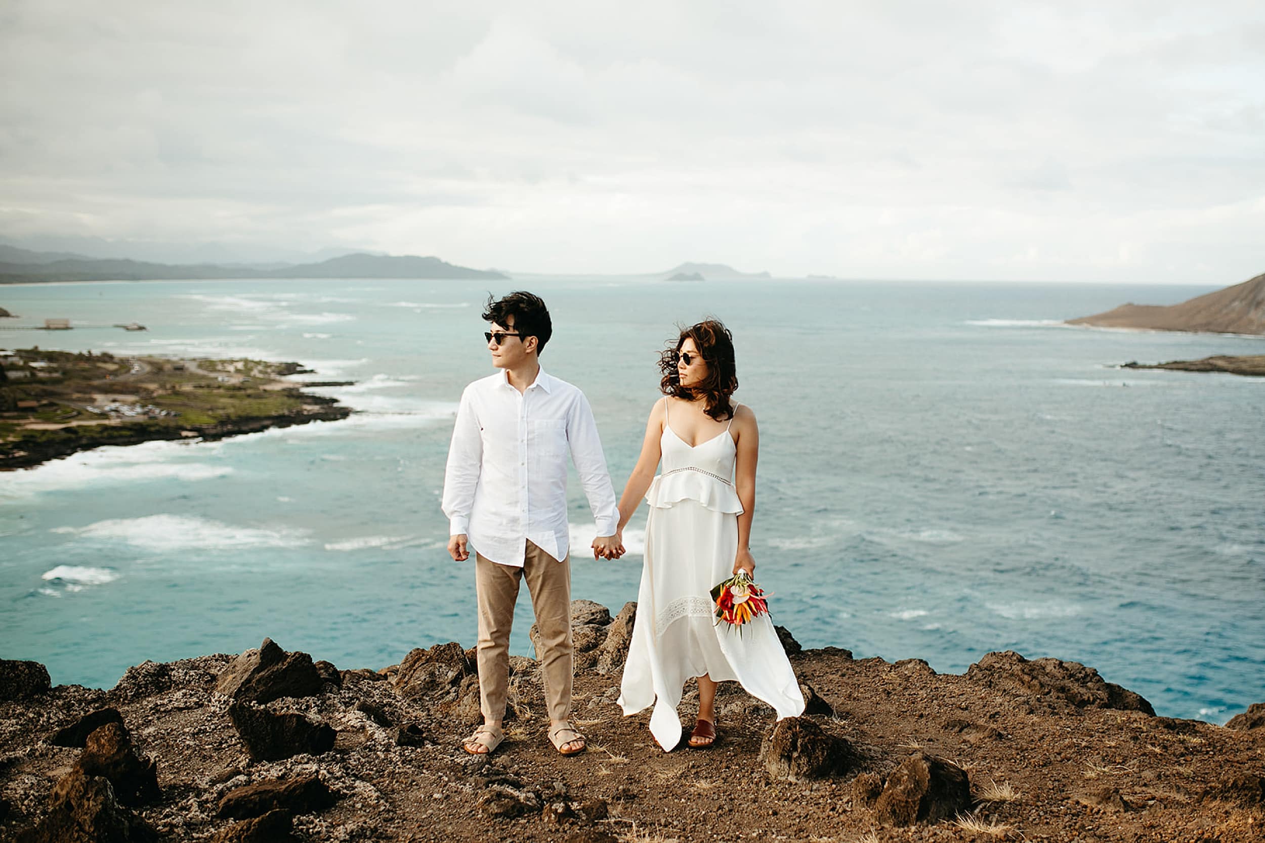 couple standing on cliff edge in Hawaii