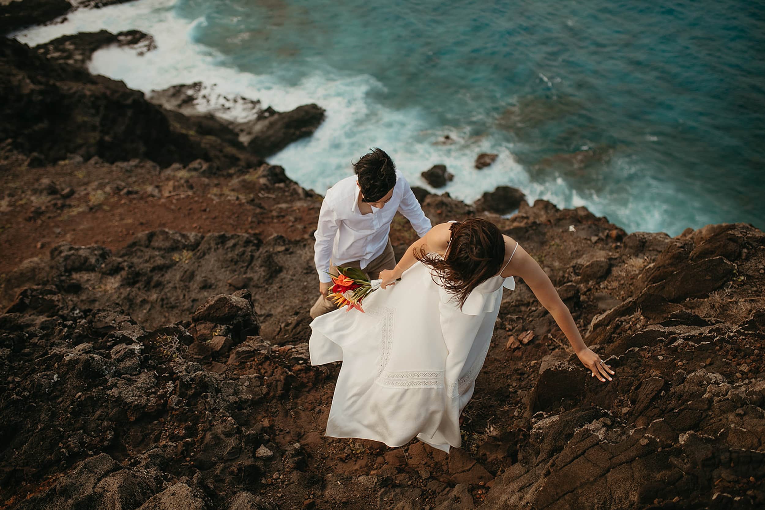 couple walking on a cliff during an Oahu elopement