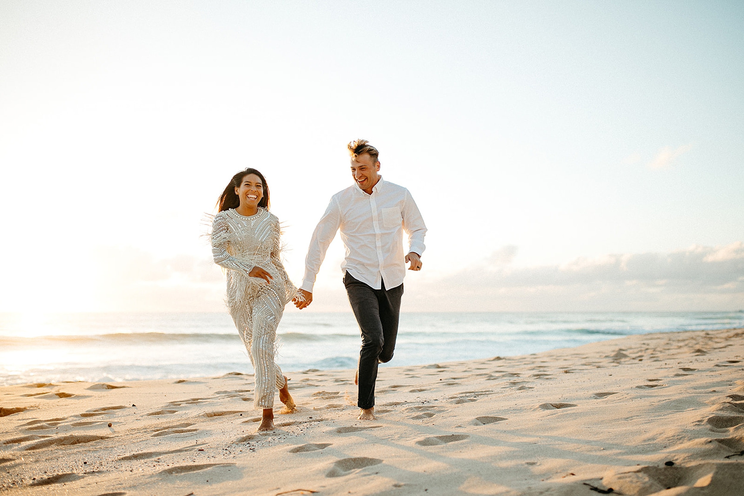 couple walking on a beach in Oahu