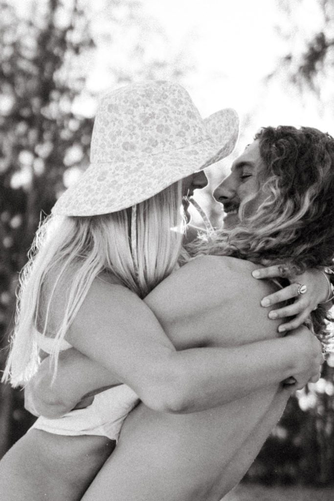 black + white photo of couple embracing in a passionate hug