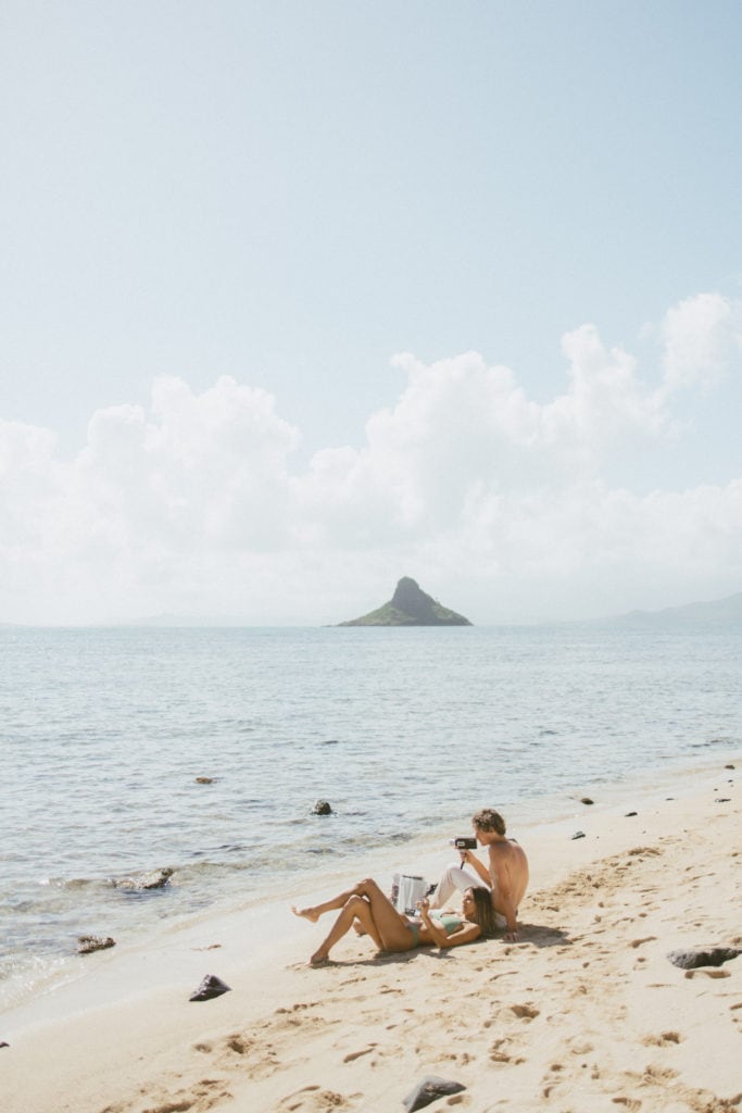 Elopement Photographer, A couple honeymoons on their destination wedding at a Hawaiian beach