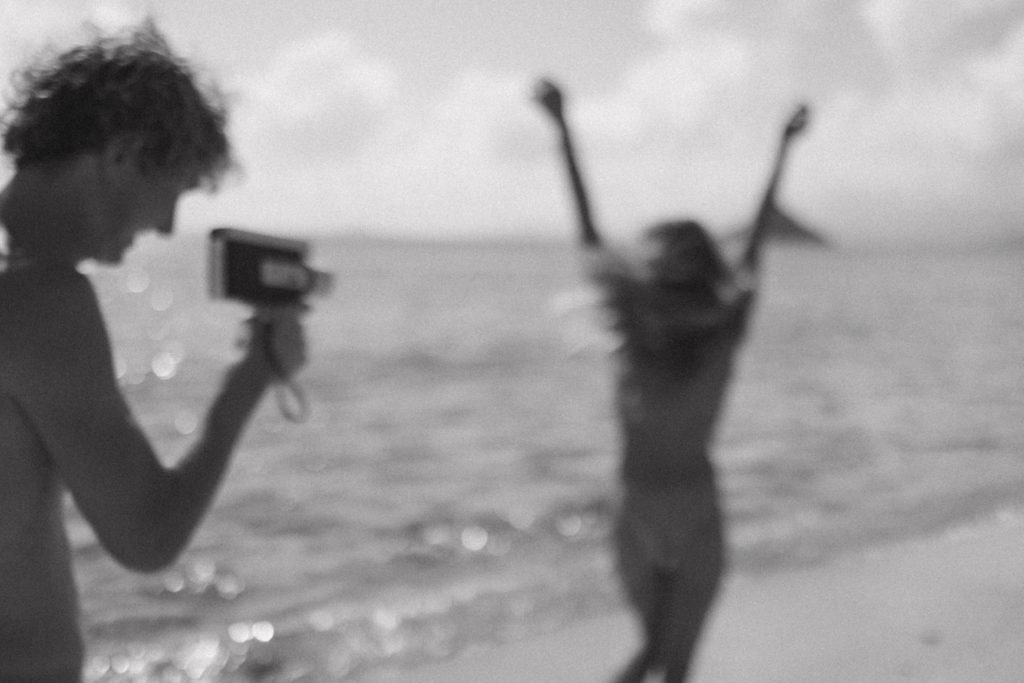 black and white picture of boyfriend taking film picture of girlfriend