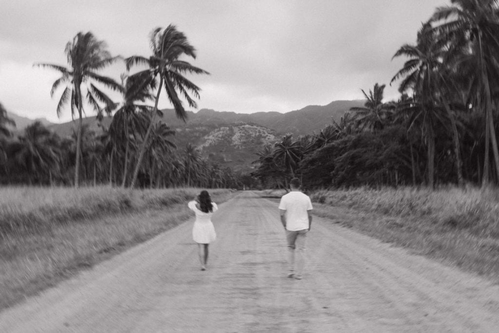 black and white portrait of couple running their destination engagement venue