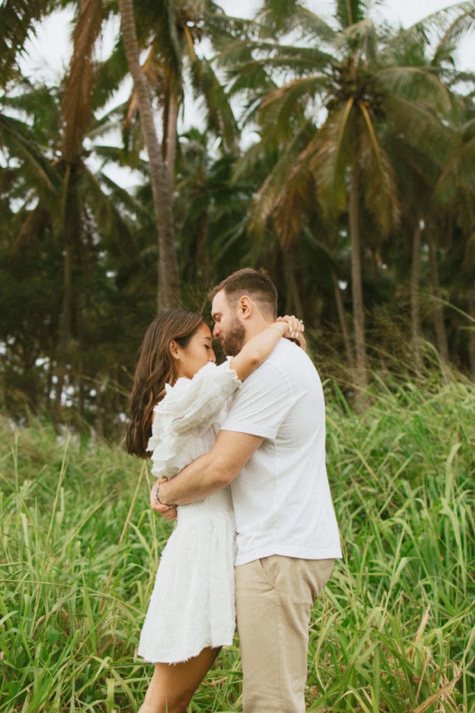 couple is holding each other in hug in the tropical forest