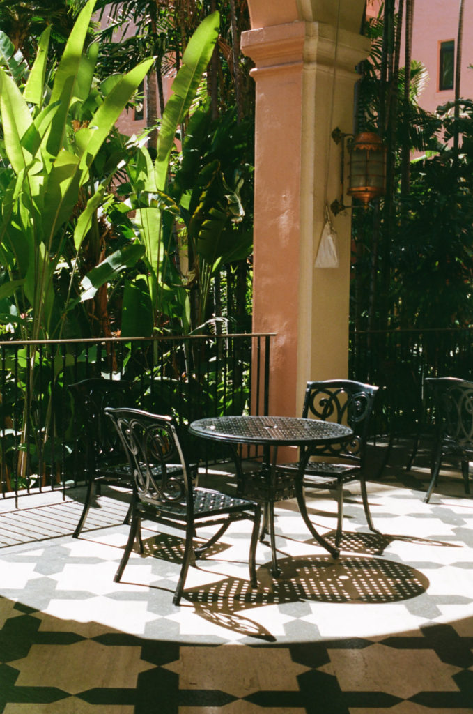 film picture of outdoor two seat table at the Royal Hawaiian Hotel