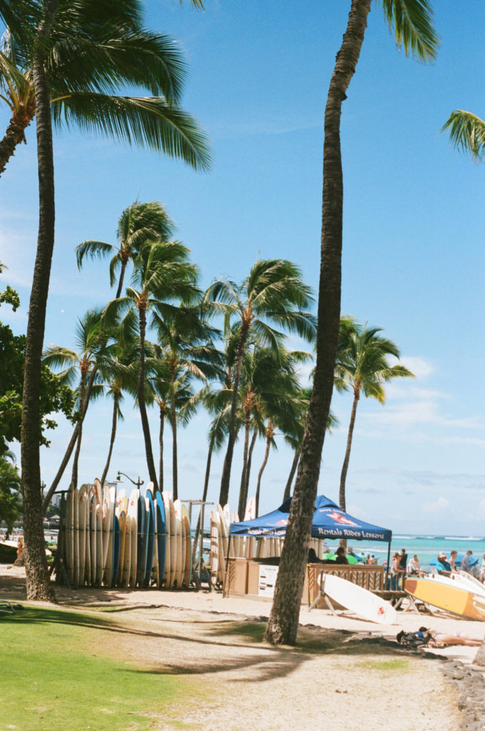 film picture of surf boards stacked at a Waikiki beach