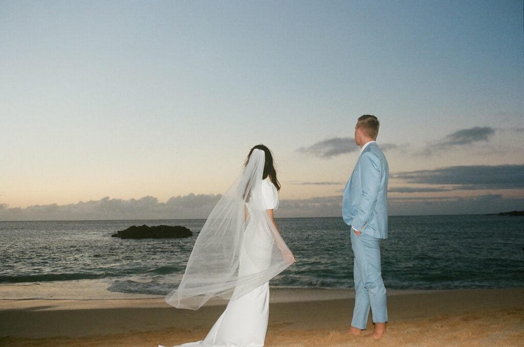 film shot of the couple looking off towards the ocean