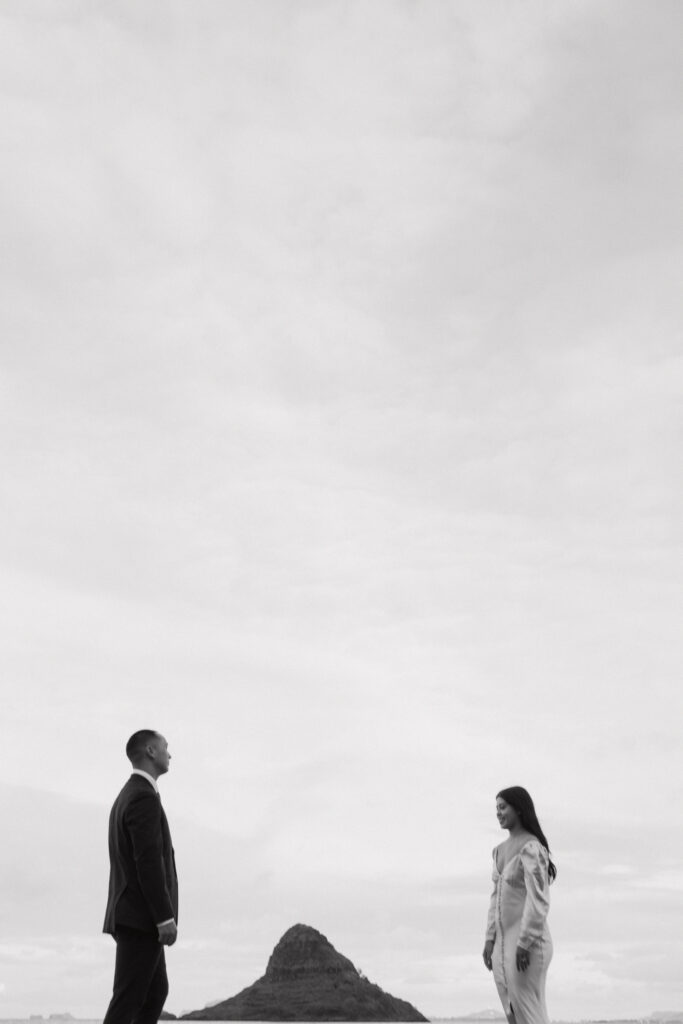 editorial black and white photo of the couple standing apart and looking away at each other