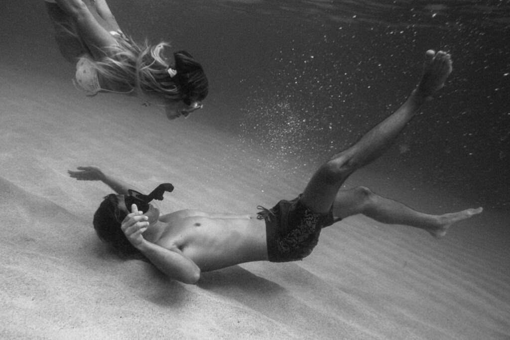 black and white underwater photo of the couple