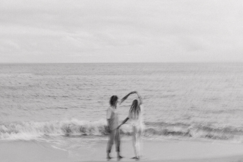 black and white blurry candid of kevin twirling jules during their couple's session