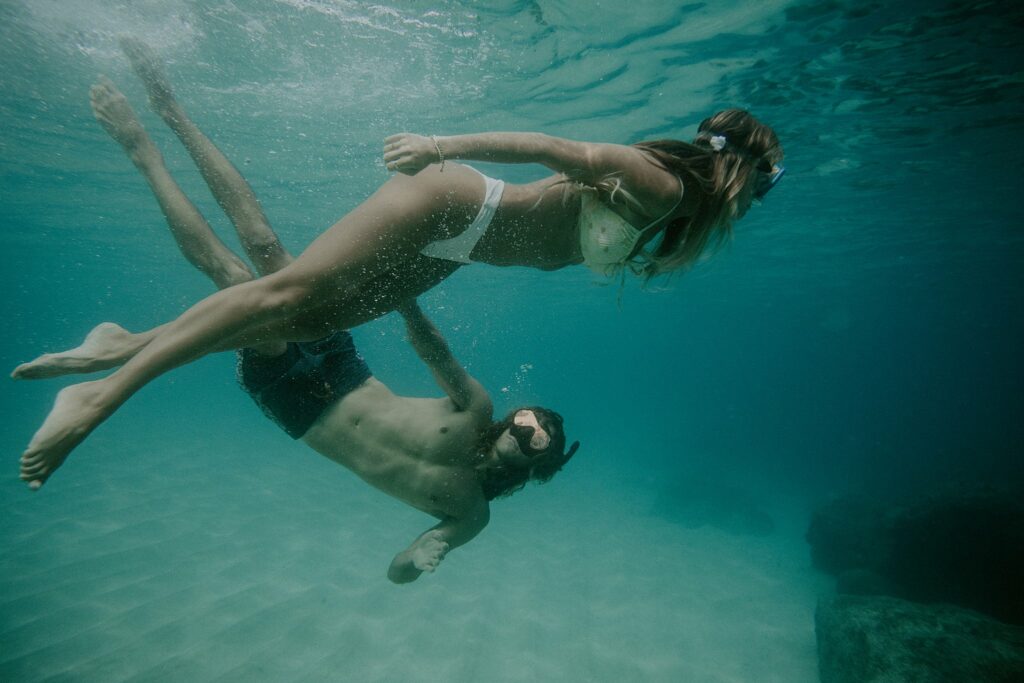underwater photo of the couple swimming 