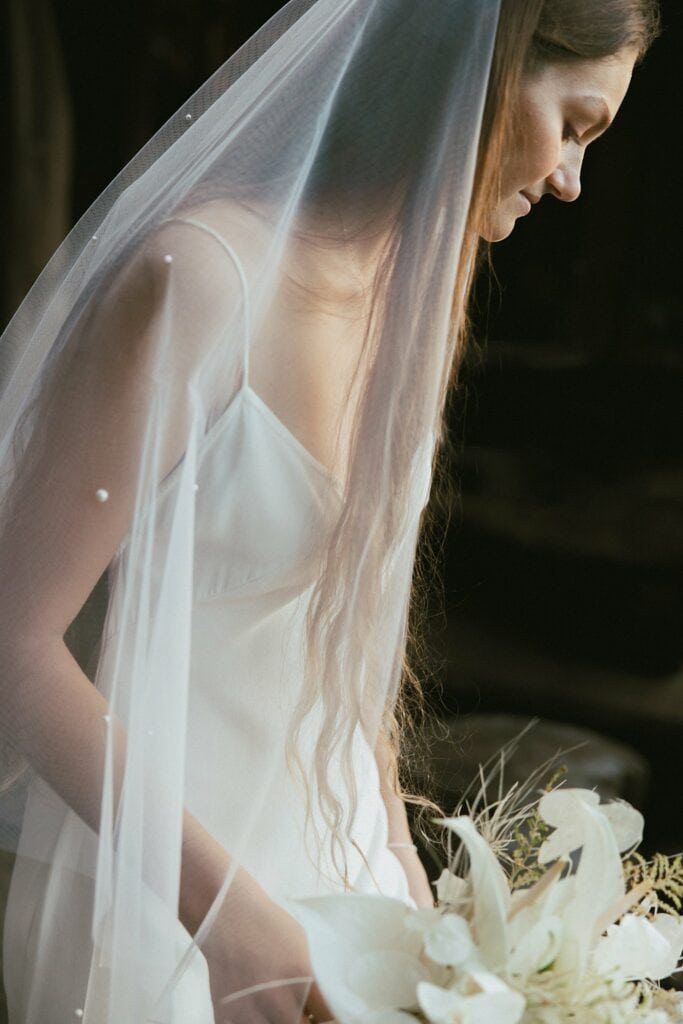 shot of the bride with her veil on and her bouquet