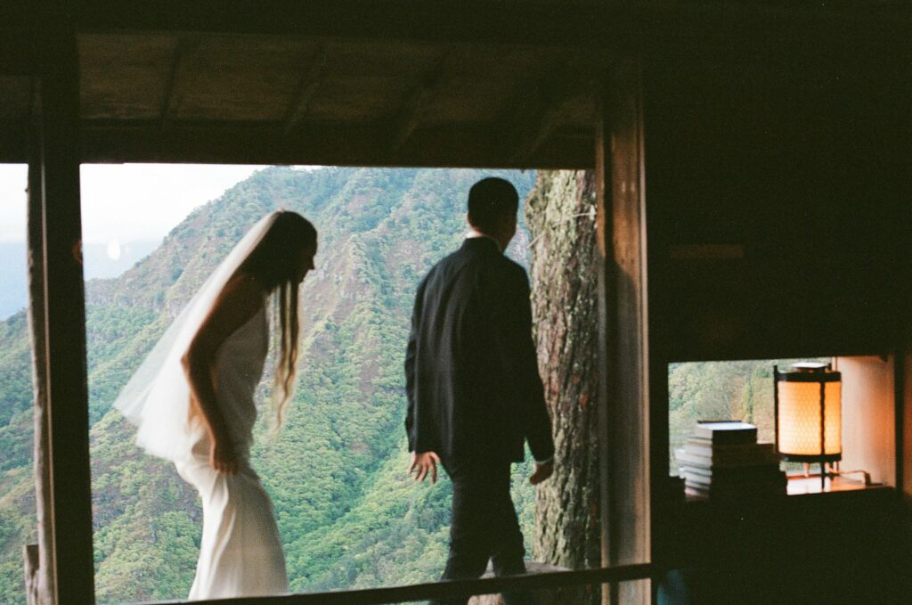 film shot of the bride and groom walking towards the door