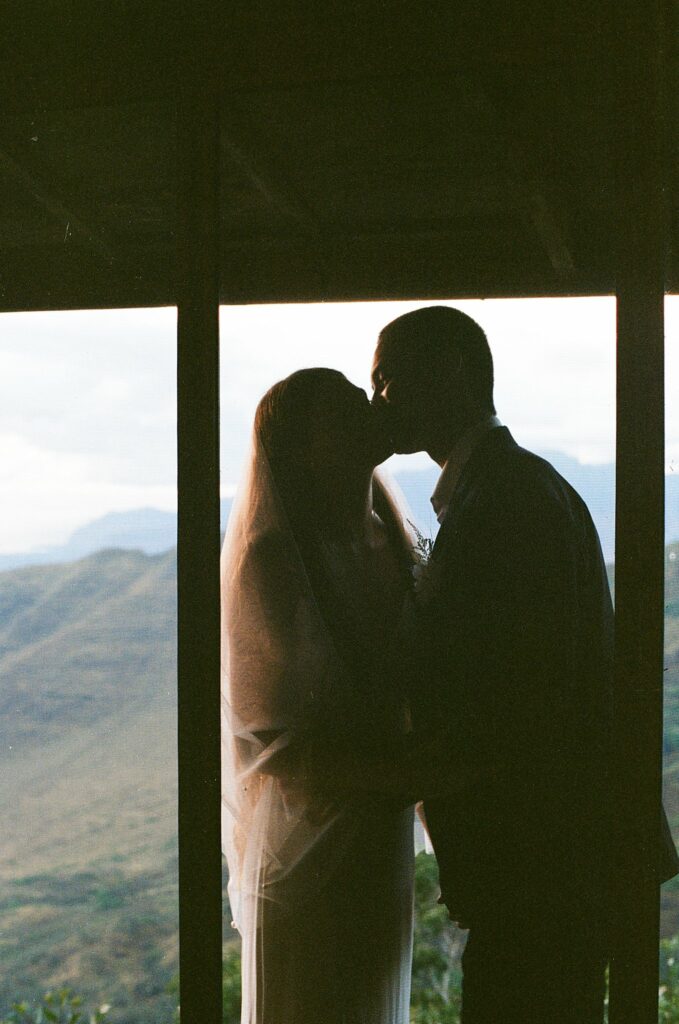 film shot of the bride and groom kissing after the first look
