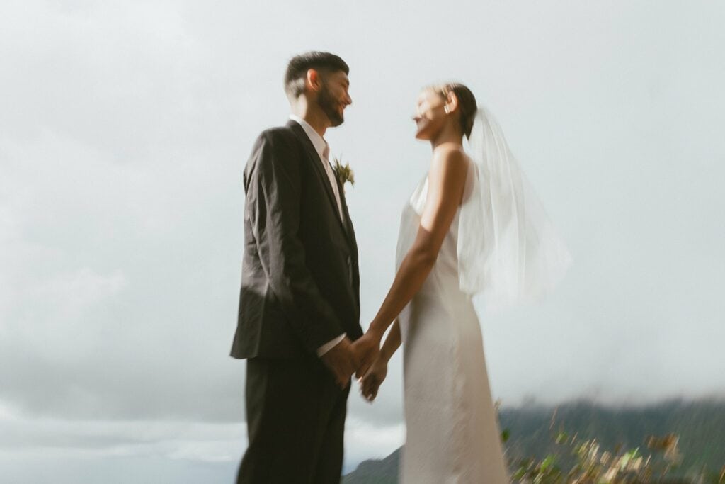 blurry photo of the bride and groom holding hands looking at each other for their zero-waste wedding