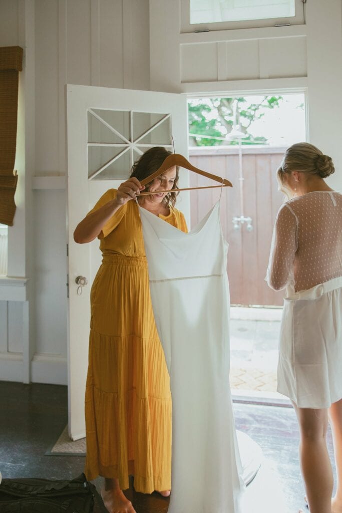 shot of the bride getting ready to put her dress on