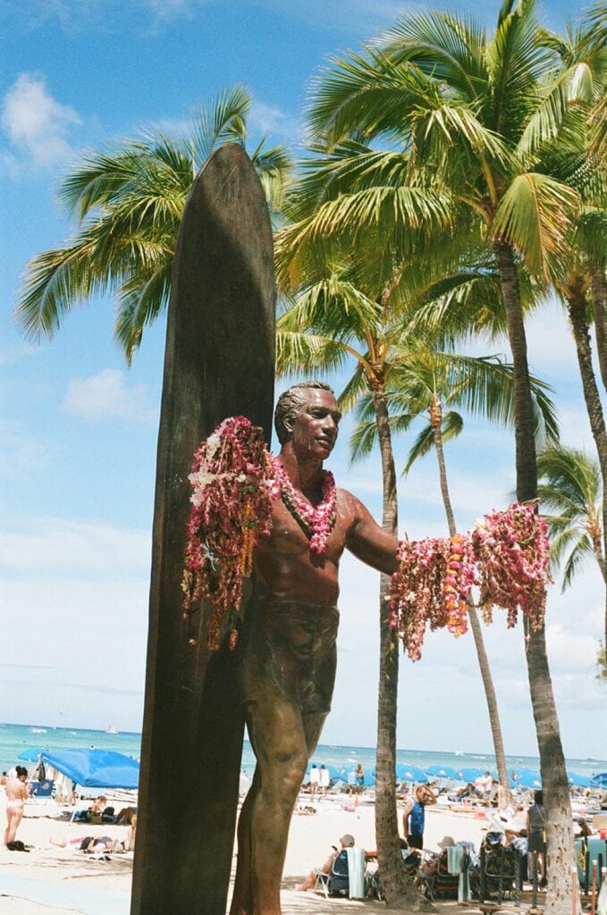 shot of statue holding leis
