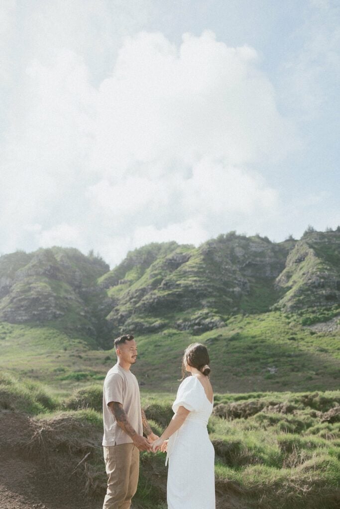 shot of couple holding hands in front of the mountains during their maternity photoshoot